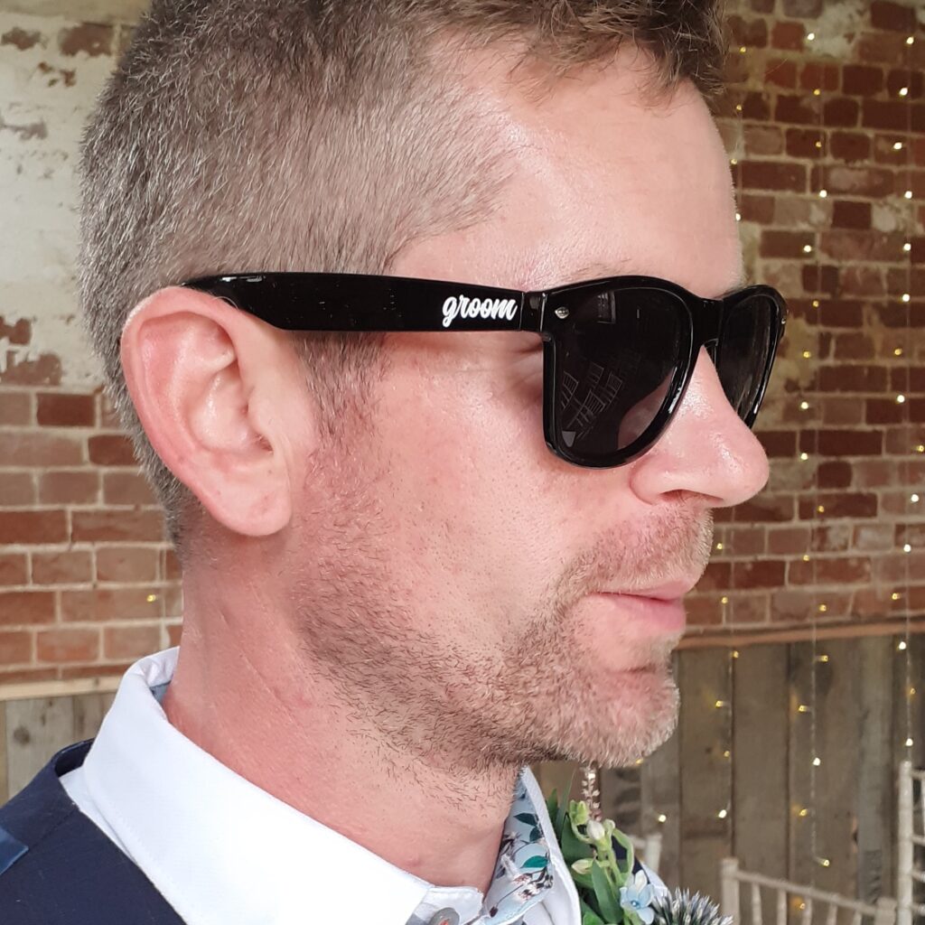 Groom with custom sunglasses on