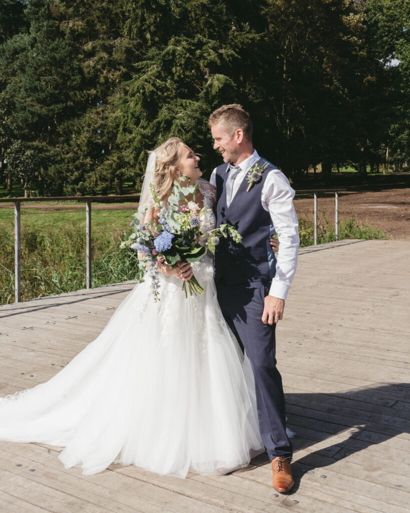 bride and groom on a bridge that is a central part of the Latitude Festival